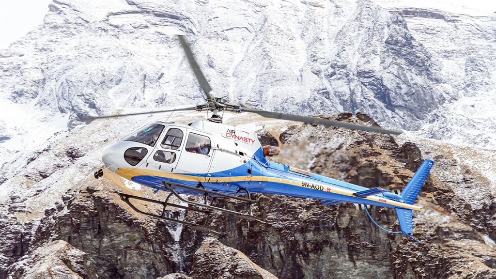 Ghandruk, Nepal - April 1, 2025: Helicopters fly in the Himalayas for various purposes, such as transporting tourists, delivering food supplies, or carrying out rescue missions.